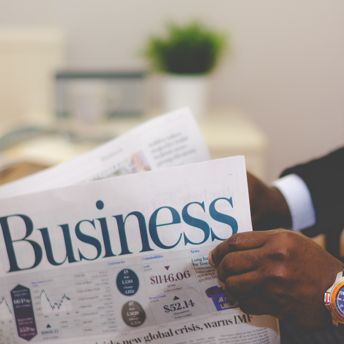 person-reading-business-newspaper