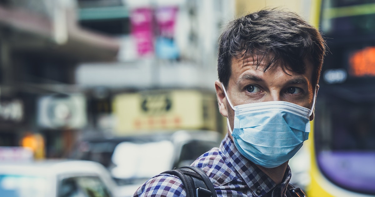 A man wearing a surgical mask in public